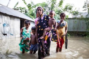 EMBARGOED FOR USE IN CAW 2016 Morsheda was eight years old when she was married. At fourteen, while pregnant with her first child, her husband left her and married another woman. Now aged between 25 and 30, Morsheda cares for her children alone. Over the years, she has been flooded out of her home several times as the mighty river around her rises. She now lives in the Bazetilcupi Char and works, where and when she can, as a daily labourer, for as little as 74 pence a day. In April and August this year, as the river flooded over the bank and into the Char, part of Morsheda’s home was flooded. With no assets and four children to care for, Morsheda told me ‘I don’t even dream that things could be better.’ It is anticipated that Morsheda will be supported through GUK’s work in the spring of 2016. In August, as the river rose, Morsheda's home was once again flooded. Morsheda and her children outside their flooated that Morsheda will be supported through GUK’s work in the spring of 2016. In